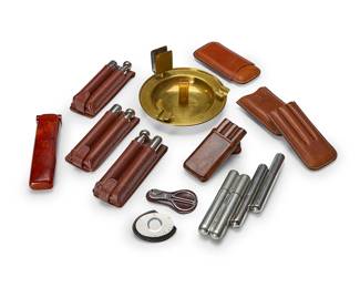 1330
A group of smoking articles
20th century
Comprising a brass ashtray with match holder, seven leather cigar cases, four stainless-steel cigar holders, and two cigar cutters
14 pieces
Ashtray: 4.25" H x 8.25" Dia.
Estimate: $200 - $300