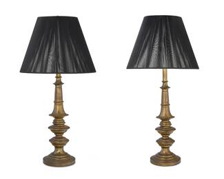 1049
A pair of turned brass table lamps
Late 20th century
Each single-light lamp surmounted by a black fabric oval shade, electrified
2 pieces
To top of base excluding mounts: 31" H; Each shade: 21" H x 16" W x 11.5" D
Estimate: $100 - $200
