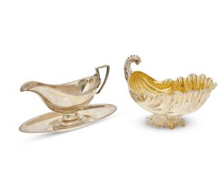 1355
Two sterling silver sauce boats
Early 20th century
Shell marked: 925 Sterling; the other boat and plate marked for Whiting, dated 1922, and each numbered respectively: 6099 / 6100
Comprising a shell-form sauce boat with a dolphin fish-form handle and a gilt interior (5.5" H x 8" W x 4.75" D), and a Whiting sauce boat with underplate (Overall: 4.25" H x 8.75" W x 4" D)
3 pieces
Total weight: 19.9 oz. troy approximately
Estimate: $400 - $600