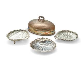 1002
A group of silver-plated and metal serving vessels
20th century
Most variously marked for maker
Comprising a silver-plated roast cover, two silver-plated shell-form serving dishes, a silver-plated scalloped footed bowl, a Rogers silver-plated shell-form dish, a Salisbury pewter scalloped tray, and an Art Deco-style silver-plated round bowl with three fan-form feet, four personalized
7 pieces
Largest: 10" H x 18.25" W x 13" D
Estimate: $100 - $150