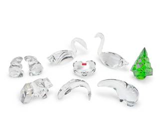 1154
A group of Baccarat and Steuben glass table items
Late 20th/early 21st century
Each with factory stencil or etched script mark
Comprising a Baccarat glass figure of a polar bear, a Baccarat glass figure of a diving dolphin, a pair of Steuben glass figures of swans, a Baccarat glass figure of a bear, a pair of Baccarat glass figures of rabbits, a Baccarat green glass figure of a Christmas tree, and a Baccarat heart paperweight in original box
9 pieces
Polar bear: 2.75" H x 6" W x 2" D; Tree: 5.25" H x 3.25" Dia.; Box: 4" H x 5.75" W x 4.75" D
Estimate: $500 - $700