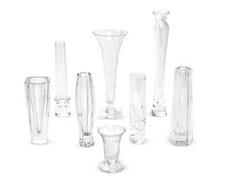 1254
A group of Contemporary glass bud vases
Late 20th/early 21st century
Each variously marked for maker
Comprising a Tiffany & Co. paneled glass bud vase (8.25" H x 2.25" Dia.), a Rogaska tulip-form glass bud vase (7.875" H x 2" Dia.), an Orrefors octagonal flared vase (7" H x 2.75" Dia.), a William Yeoward trumpet-form etched glass vase with square foot and etching of vinery and beads (10.5" H x 4" Dia.), a William Yeoward flared etched vase with round foot (4" H x 2.5" Dia.), a Steuben tall vase (13" H x 2.5" Dia.), a Steuben footed glass bud vase with a cylindrical foot (9.25" H x 2" Dia.), and a Steuben glass bud vase with spiral-form ribs to the base (7.5" H x 2" Dia.)
8 pieces
Estimate: $200 - $300