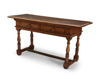 1215
A Continental Baroque-style walnut library table
18th century with later elements
With dentil molding, fitted with two drawers on turned legs joined by an H-form stretcher, the drawers later lined in a moiré fabric
34" H x 65" W x 25" D
Estimate: $300 - $500
