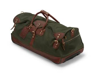 1279
An Orvis roll-away duffle travel bag
Late 20th/21st century
Marked for maker
A large green canvas bag with brown leather trim and handles and brass toned hardware, with overflap to top and multiple pockets, as well as a collapsible handle and two wheels
13" H x 30" W x 15" D excluding handle
Estimate: $200 - $300