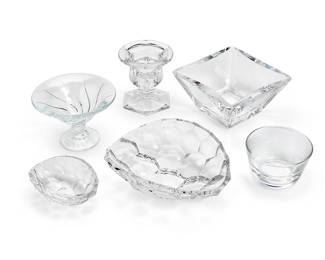 1148
A group of Contemporary glass table items
Late 20th/early 21st century
Three etched: Steuben; square bowl etched: Kosta Boda / 57847 / [signed indistinctly]; candle holder with Royal Doulton factory stencil mark
Comprising a Kosta Boda square bowl (3.5" H x 6.5" W x 6.5" D), a Durand flared and footed compote, a Royal Doulton footed candle holder (4.5" H x 4.25" Dia.), two Steuben faceted shallow bowls (Larger: 3" H x 9" W x 7" D), and a small Steuben bowl (3" H x 4.25" Dia.)
6 pieces
Estimate: $100 - $200