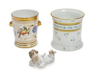 1147
Two Continental porcelain cachepots and a Lladró figure of an angel
20th century
The first stamped to underside: Ceralene / A. Raynaud et Cie / Limoges; the figure marked for Lladró and impressed: 45419
Comprising an A. Raynaud et Cie Ceralene Limoges cachepot with gilt yellow banding and blue morning glories (5.5" H x 5.5" Dia.), a cachepot decorated with flowers and a parrot (5.5" H x 4.75" Dia.), and a Lladró porcelain figure of a reclining angel designed 1970 by Fulgencio García (3" H x 6" W x 3" D)
3 pieces
Estimate: $200 - $300