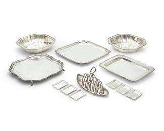 1342
A group of silver-plated trays and serving vessels
19th/20th century
Some variously marked
Comprising a group of 6 square, rectangular, and scalloped serving trays and bowls, 3 round serving trays and bowls, and 4 sets of butter pats including 7 of rectangular form, 7 of square form, 5 of oval form with two handles, and 4 of lozenge form, together with a toast rack with an attached stand
33 pieces
The largest: 1" H x 12.25" W x 12.25" D; The largest round tray 13.5" Dia.; Toast rack: 6" H x 9.5" W x 4" D
Estimate: $200 - $400