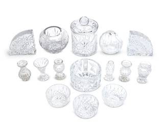 1298
A group of assorted glass table items
20th century
Each Waterford with etched factory mark; wine coaster with factory paper label; biscuit barrel etched: BLOCK
Comprising examples by Waterford including three small cut glass bowls, a cut glass basket, a wine coaster, and pair of pie-shaped cut glass bookends, together with six bud vases, a cut glass bowl, and a biscuit barrel
15 pieces
Each bookend: 5.25" H x 5.25" W; Biscuit barrel: 7.75" H x 5.25" Dia.
Estimate: $400 - $600