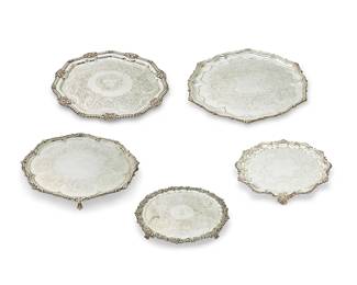 1348
A group of silver-plated trays and platters
19th/20th century
Some variously marked for maker
Comprising two round footed serving trays with gadrooned rims, three other large round serving trays, six oval serving trays including two with galleries and five with handles, three round footed serving trays; and seven more oval and round serving trays and platters, including two with wood inserts and one with a glass insert
21 pieces
Largest: 3" H x 24" W x 14.25" D; Largest circular: 21" Dia.
Estimate: $300 - $500