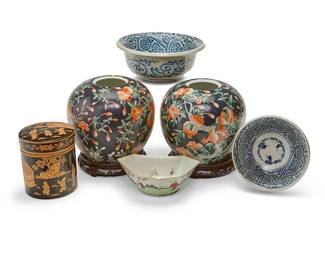 1210
A group of East Asian porcelain vessels
20th/21st century
Each jar with apocryphal red reign mark to underside and applied sticker: C P C / Made in Macau; each other item with a red or blue underglaze mark
Comprising a graduated pair of blue and white porcelain bowls, a Chinese Famille Rose lozenge-form dish decorated with figures in a landscape, flowers and bats, a Chinese cylindrical lidded jar depicting figural scenes of maidens and children in brown on a black ground, and a pair of Chinese ginger jars on hardwood stands
6 pieces
Largest graduated: 4.25" H x 10.25" Dia.; Dish: 3" H x 8.25" W x 5.5" D; Jar: 6.25" H x 5.375" Dia.
Estimate: $100 - $150