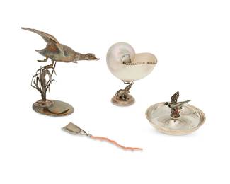 1009
A group of Continental silver table items
Late 20th/early 21st century
Ashtray marked for maker and for sterling; flying marked: Spain / Sterling / 925; shell marked indistinctly, and coral unmarked
Comprising an Italian .800 silver and coral spoon, an Italian .800 silver-mounted nautilus shell supported by an elephant-form base, a Romeo Miracoli & Figlio sterling silver dish with a polychrome-painted duck-form finial, and a Spanish sterling silver figural group of a duck in flight
4 pieces
Largest: 8.125" H x 7.5" W x 6.5" D; Spoon: 7" L; Dish: 2.5" H x 5" Dia.
Weighable sterling: 11.7 oz. troy approximately
Estimate: $400 - $600