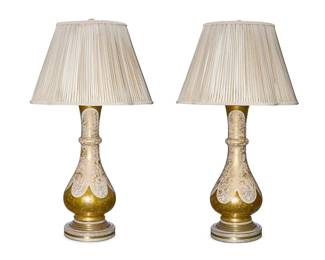 1269
A pair of églomisé glass table lamps
Mid-20th century
Each baluster form single-light base mounted on a circular metal base, surmounted by a pleated fabric shade, electrified
2 pieces
Each lamp without harp or shade: 27" H x 8.75" Dia.; Each shade: 12.75" H x 20.25" Dia.
Estimate: $400 - $600