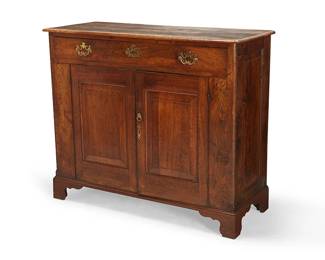 1155
A George III oak chest
Late 18th/early 19th century
With a single drawer above two locking cupboard doors revealing a single shelf, each with updated brass hardware, on later bracket feet
41" H x 48" W x 19.5" D
Estimate: $700 - $900