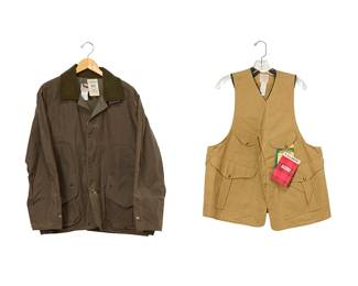 1115
Two Filson outdoor jackets
21st century
Each with labels and original tags
Comprising a new Filson Original tan hunting vest in heavy 10 oz. cotton duck fabric, with multiple interior and exterior pockets (size L), as well as a new Filson "Upland Coat" in green waxed cotton with tonal brushed cotton collar, multiple pockets, and with double snap and button front closure and ribbed inner sleeves
2 pieces
Vest: half chest: 23"; center back: 26"; Coat: half chest: 26"; center back: 28"; sleeve: 25"
Estimate: $50 - $100