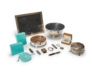 1245
An assorted group of sterling silver items
20th century
Most marked for sterling; some marked for Tiffany & Co.; pen marked: Jean Pierre Lepine / Made in France / 2000; box with English hallmarks for Birmingham
Comprising an English sterling footed jewelry box (personalized), a Tiffany & Co. Revere-style footed bowl (personalized), an English sterling and wood wine coaster, a Tiffany & Co. sterling easel-back picture frame with moiré backing, a pair of Ballesteros knotted sterling cuff links in original leather box, and a group of Tiffany & Co. sterling articles including a book-form match holder, two key chains with tags, two Swiss army knives, and a bookmark, together with a Jean Pierre Lepine metal and wood ballpoint pen
12 pieces
Frame: 10" H x 8" W; Bowl: 3.5" H x 7" Dia.
Estimate: $300 - $500