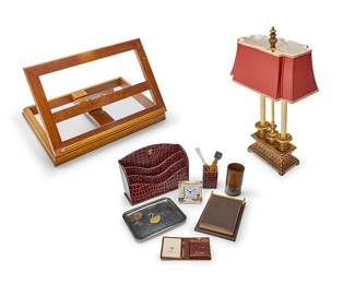 1253
A group of desk accessories
Late 20th/early 21st century
Comprising a Drexel adjustable wood dictionary stand and a two-light candelabra-style lamp with a polychrome and gilt composite base, together with an assorted collection of accessories
11 pieces
Stand stored: 3.5" H x 20.5" W x 13.25" D; Lamp: 26" H
Estimate: $300 - $500