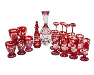 1257
A group of ruby cut-to-clear glassware vessels
Late 20th/early 21st century
Comprising a tall vase (13.5" H), a cruet and stopper (10.875" H), a set of five footed tumblers (5.25" H), a set of eight footed glasses (7" H), and a set of four stemmed cordials (3.5" H)
19 pieces
Estimate: $200 - $300