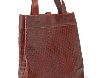1082
A Henry Beguelin 'Russel' woven leather tote bag
Late 20th/21st century
Marked for maker; Made in Italy; with a "Certificato di Unicita"
A tall hand-crafted woven leather tote with smooth leather top edge and handles, with contrast accent stitching and small interior pocket (model No. 21)
Overall: 14.5" H x 12" W x 5" D; Handle drop: 6"
Estimate: $150 - $250