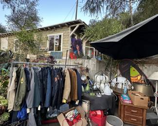 Chandeliers and coats. Lots of vintage and costume police outfits plus army shirts and pants. May styles of camo