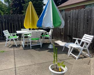 Two vintage umbrellas and other outdoor furniture