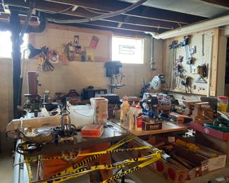 Woodshop full of wood scraps and kits, tools, clamps, Rigid table saw, cast-iron, sawhorses and stands, Miter saws, Ryobi jigsaw, Radio arm saw, toolboxes, lots of product, nails, screws, Jet jigsaw on stand, Craftsman jigsaw, bench grinder, Misc. machinery, belt sander.