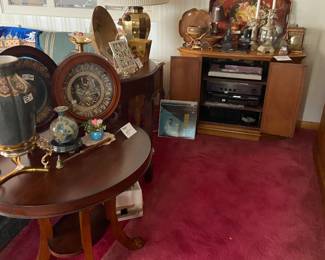 Several side tables, sofa tables and cabinets along with lots of electronics including TV's, stereo, DVD player, cameras, clocks and more