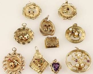 Group of (10) 14k yellow gold charms. Approximately 44.2 grams TW. Provenance: Methuen, Massachusetts estate. PLEASE NOTE: payment for silver, gold, jewelry, and coins must be made via wire transfer, cash, or certified bank check ONLY. The only exception is long-standing customers.