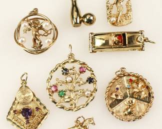 Group of (8) 14k yellow gold charms. Approximately 37.5 grams TW. Provenance: Methuen, Massachusetts estate. PLEASE NOTE: payment for silver, gold, jewelry, and coins must be made via wire transfer, cash, or certified bank check ONLY. The only exception is long-standing customers.