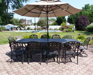 Outdoor large cast aluminum dining table with 10 chairs & umbrella