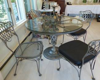 Glass top metal base dining table with 4 metal chairs