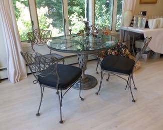 Glass top metal base dining table with 4 metal chairs