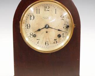 An early 20th century Seth Thomas "No. 214" model 8-bell Sonora chime mantel clock.  8-day time and strike #90D movement with quarter hour striking on eight Sonora bells in Westminster/Whittington Cathedral chimes, Silvered dial with Arabic numerals.  Mahogany case with Gothic arched top and Brass dial door.  Old finish with minor wear, some dial wear, running when cataloged.  14 1/4" high.  ESTIMATE $600
