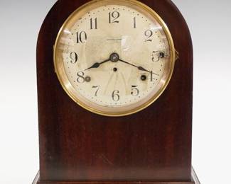 An early 20th century Seth Thomas "No. 214" model 8-bell Sonora chime mantel clock.  8-day time and strike #90D movement with quarter hour striking on eight Sonora bells in Westminster/Whittington Cathedral chimes, Silvered dial with Arabic numerals.  Mahogany case with arched top and Brass dial door.  Old finish with minor wear, some dial wear, running when cataloged.  14 1/4" high.  ESTIMATE $600-800
