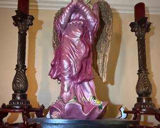 Large painted angel statue with wood pillar candlesticks