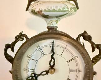 Detail of clock and hand painted ceramic finial