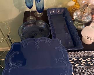 Blue serving dishes and glassware, serving trays and blue wine glasses.