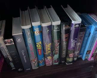 various VHS tapes including Disney (Toy Story, Alice in Wonderland, Babe, Tarzan, and more)