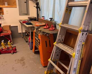 Ladder with planer and car working accessories in the background.