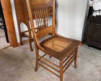 Sturdy antique chair with caned seat.