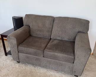 Comfortable steel grey love seat in good condition.