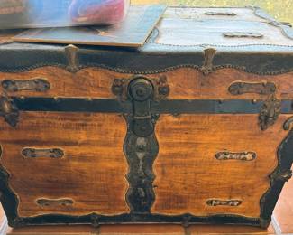 Multiple vintage wooden travel trunks