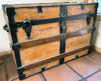 Multiple vintage wooden travel trunks