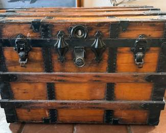 Multiple vintage wooden travel trunks