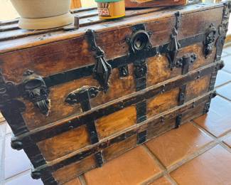 Multiple vintage wooden travel trunks