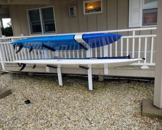Stand-Up Paddleboards with paddles; storage rack