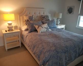 Upholstered queen bed; set of two nightstands; two table lamps