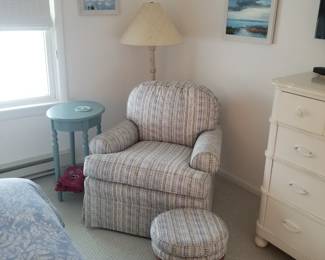Upholstered arm chair with matching foot stool; accent table; floor lamp