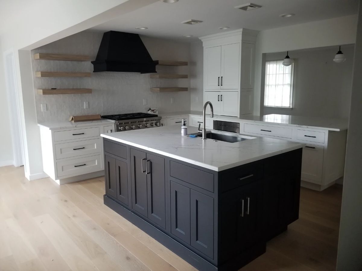 U-shaped kitchen with island, peninsula & wet bar. Cabinetry by CABICO. Cabinets are black and white