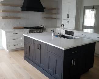 U-shaped kitchen with island, peninsula & wet bar. Cabinetry by CABICO. Cabinets are black and white