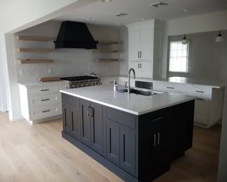 U-shaped kitchen with island, peninsula & wet bar. Cabinetry by CABICO. Cabinets are black and white